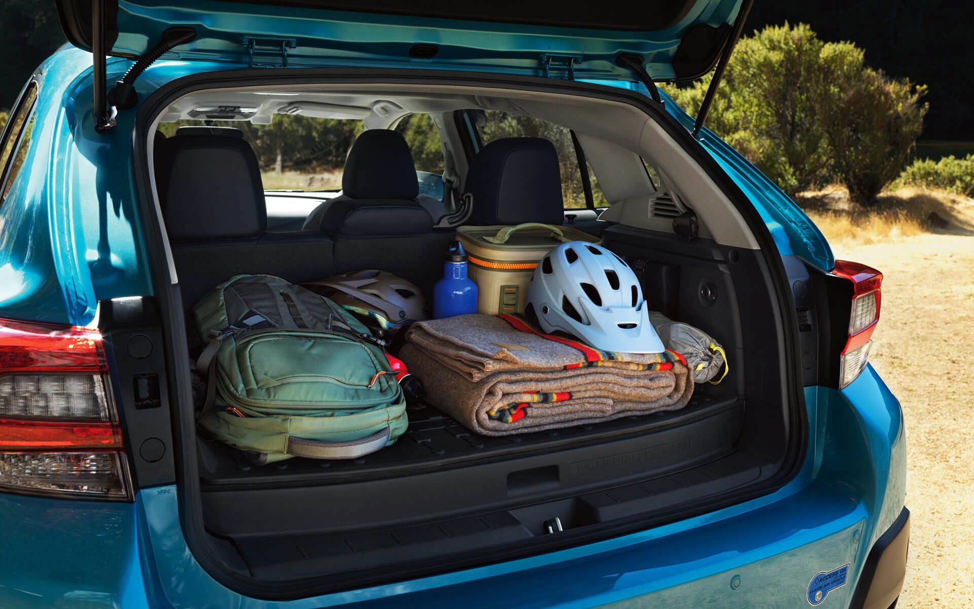 A backpack, blanket, and bike helmet in the rear cargo area of a Crosstrek Hybrid | Subaru of Spartanburg in Spartanburg SC