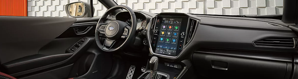 Interior of a Subaru vehicle showing off the infotainment system and dashboard